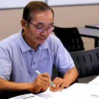 Students challenge their skills by filling out crossword puzzles using common words they have learned.