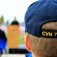 Veteran watching a speaker at veterans day ceremony