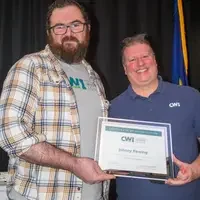 Winners hold their certificates at a faculty professional development event.