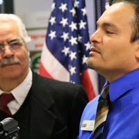 Luis Caloca speaking at donation event.