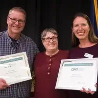Winners hold their certificates at a faculty professional development event.
