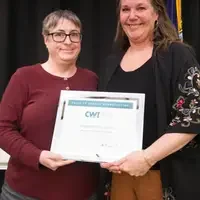 Winners hold their certificates at a faculty professional development event.