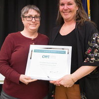 Winners hold their certificates at a faculty professional development event.