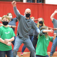 Students and children dancing
