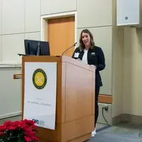 Student speaking behind a podium