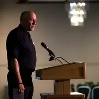 Kevin Platts, Director of Public Safety Programs, congratulates graduates during the ceremony. 