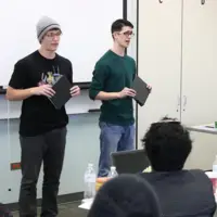 Students speaking in front of a group at Rookie Debate Tournament