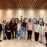 Group of people standing in front of Micron sign