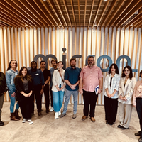 Group of people standing in front of Micron sign
