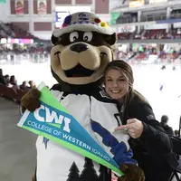 Enrollment Counselor, Hailie Martell, posing with Blue