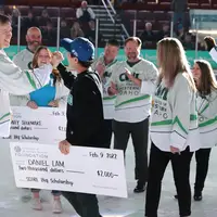 SCORE Big Scholarship recipient, Daniel Lam, high fives President Jones