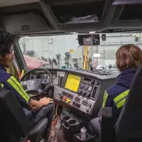 Students look at the interior of a newly donated 2018 Daimler Cascadia Freightliner.