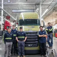 Students pose in front of a newly donated 2018 Daimler Cascadia Freightliner.
