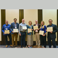 Dean Greg Wilson standing with a group of fellow award receipients