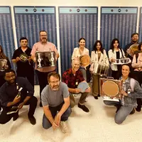 Group of people holding technology and tools