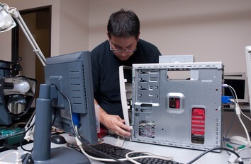 Person working on the inside of a computer tower