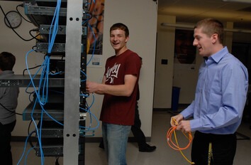 Students working on wiring to servers in lab