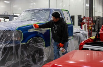 CWI Student sanding and cleaning Bondo on the body of a vehicle