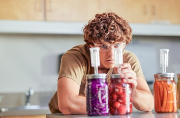 Person looking at jars of fermented food