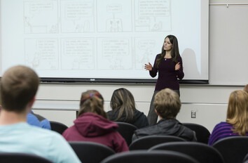 Instructor giving a lecture in-front students in classroom