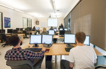 Students working at computers in software development classroom