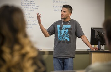 Student presenting at the front of a classroom