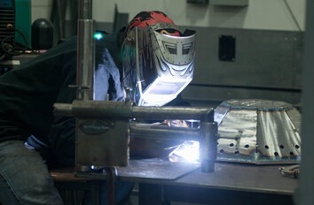 Welding student welding in lab