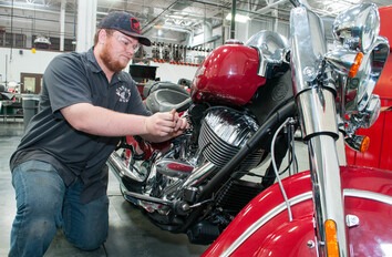 Student working on motorcycle