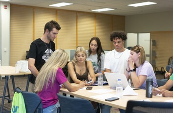 Students in study group at table in classroom