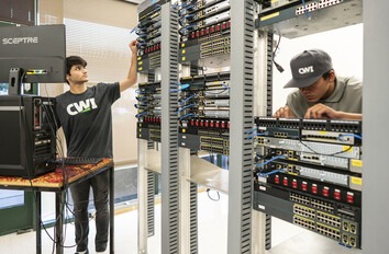CWI students in a network lab looking at cables
