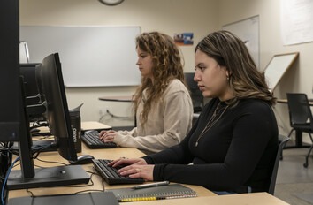 Two CWI students working on computers