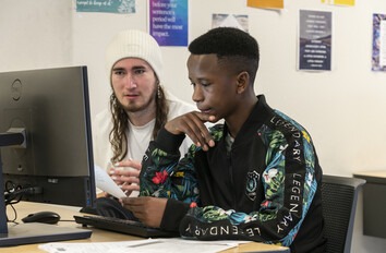 Two students studying at a computer