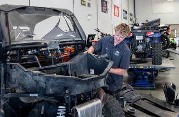 Student working on side by side in Powersports and Small Engine Repair Lab