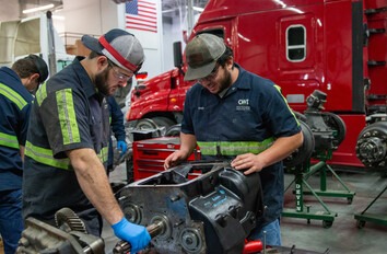 Two CWI Students working on a truck transmission