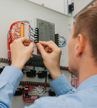 Person working on low voltage electrical equipment