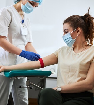Phlebotomist taking blood from a patient