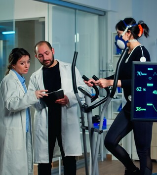 People in exercise lab analyzing monitors