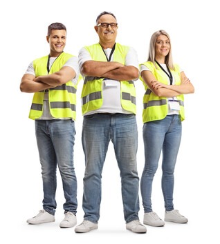 Three people standing together all wearing safety vests