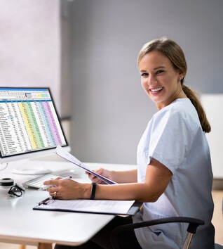 Medical Coding and Billing specialist working on a computer in a office