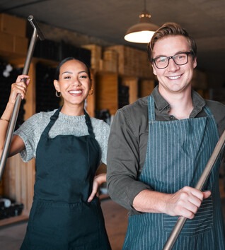 Two people holding fermentation tools