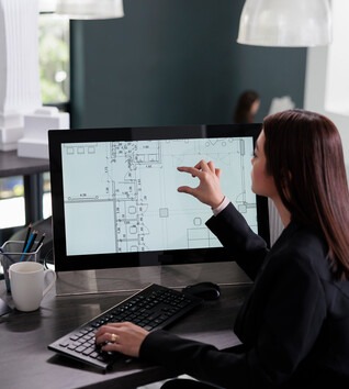 Person at a desk with multiple computer screens