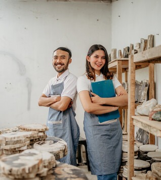 Two people standing in a workshop