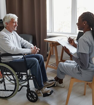 Practical Nurse working with patient in a wheelchair
