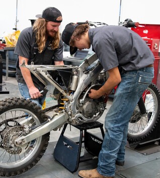 Technicians working on a motorcycle