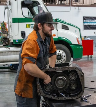 Heavy-Duty Truck Technician working on truck engine