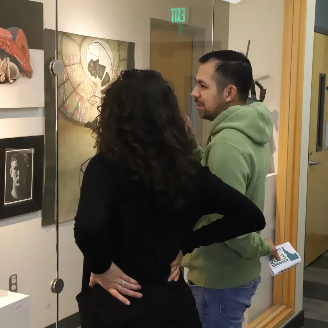 Two people looking at the art gallery wall