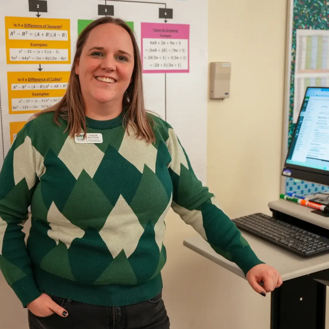 Person standing next to a computer