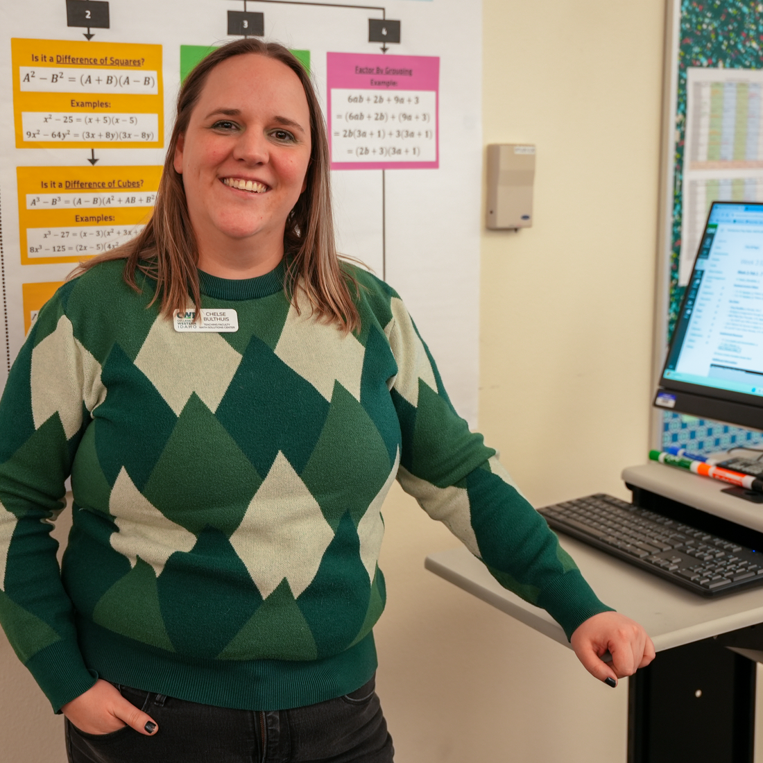 Person standing next to a computer
