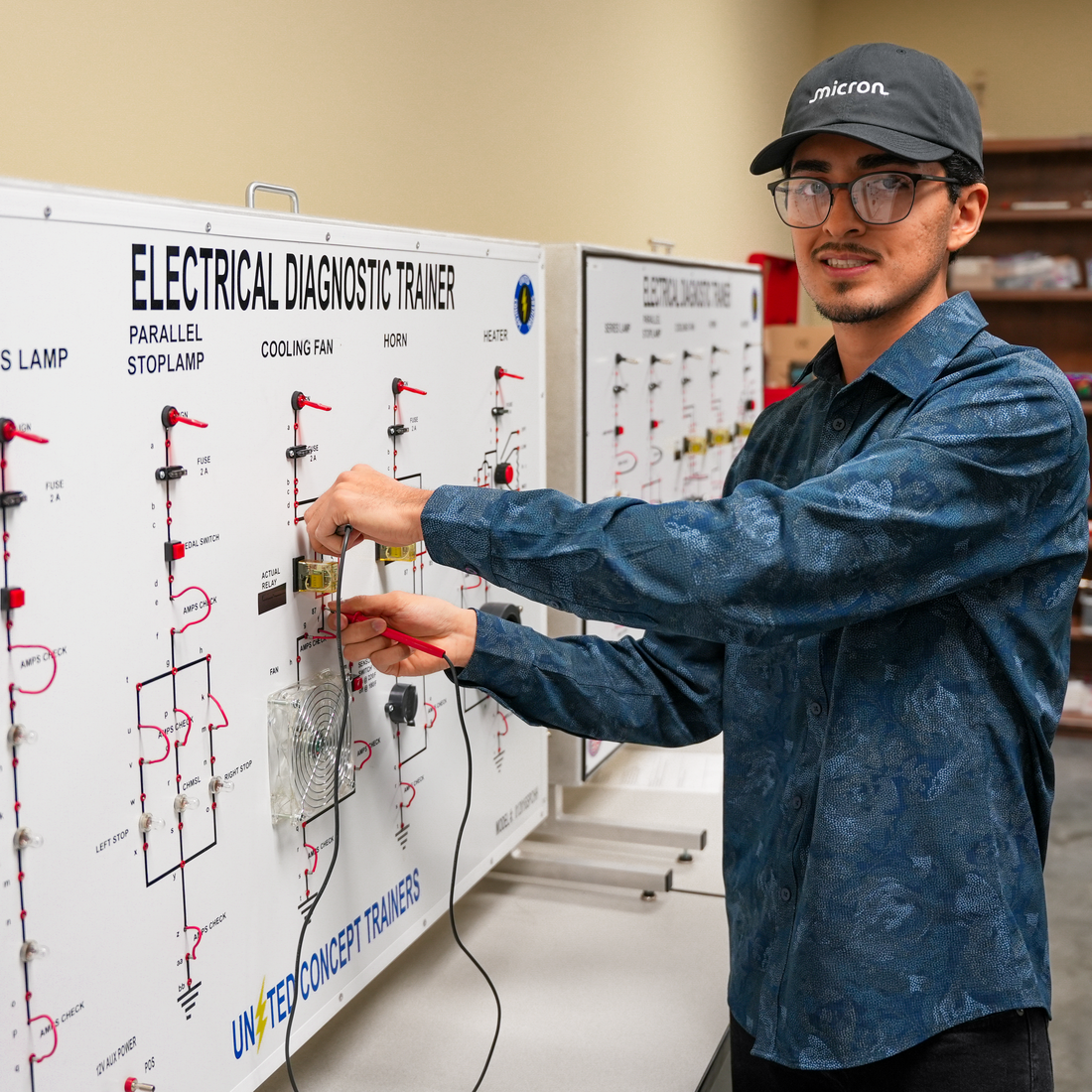 Student at board with wires 