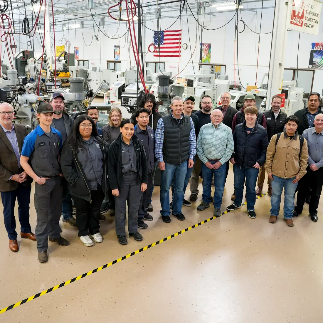 Group of people stand in Machine Tool lab